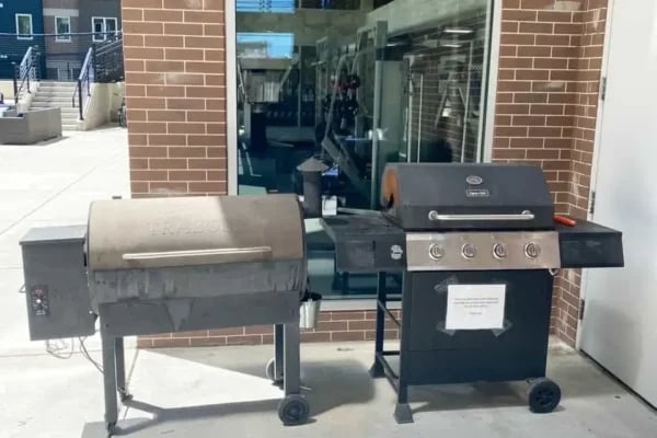 Two outdoor grills on patio exterior at The Factory Student Housing in Logan Student Accommodation