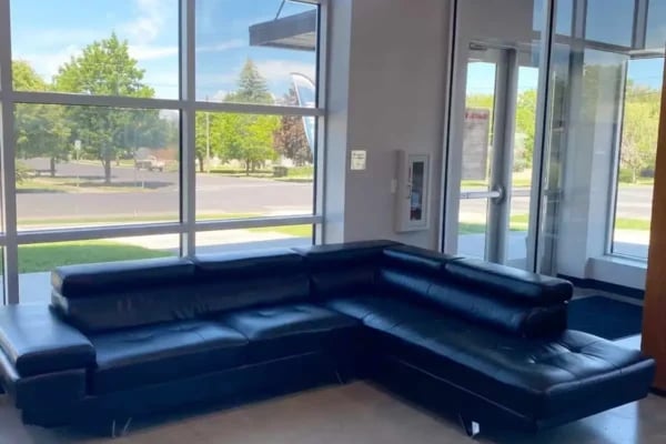 black sectional sofa large windows exterior at The Factory Student Housing in Logan Student Accommodation