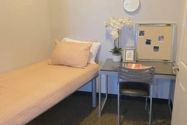 Bed desk chair corkboard plant framed picture bedroom at The Factory Student Housing in Logan Student Accommodation