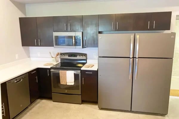 Stainless steel appliances dishwasher oven refrigerator kitchen at The Factory Student Housing in Logan Student Accommodation