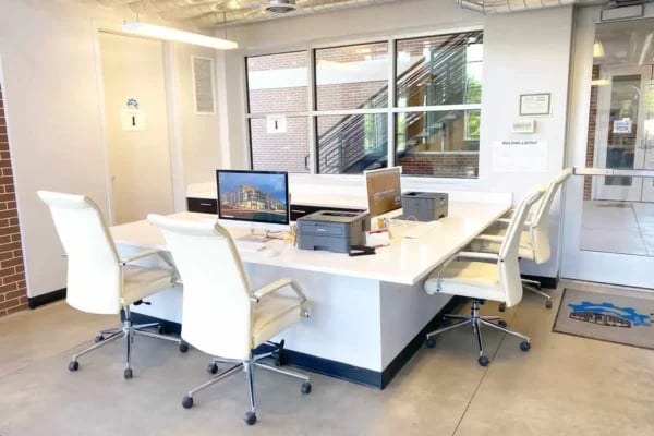 Modern workspace with white chairs and computers study area at The Factory Student Housing in Logan Student Accommodation