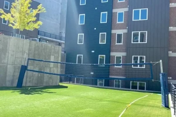 Volleyball net on artificial turf playing area exterior at The Factory Student Housing in Logan Student Accommodation