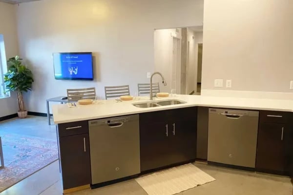 Modern kitchen with stainless steel appliances and island kitchen at The Factory Student Housing in Logan Student Accommodation
