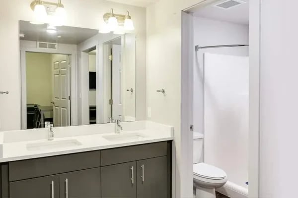 Double vanity toilet shower stall bathroom at The Factory Student Housing in Logan Student Accommodation