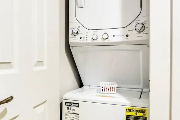 Stacked washer dryer with basket laundry area at The Factory Student Housing in Logan Student Accommodation