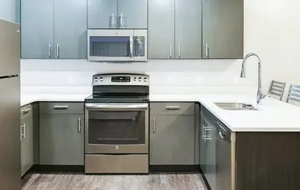 Stainless steel appliances gray cabinets and countertops kitchen at The Factory Student Housing in Logan Student Accommodation