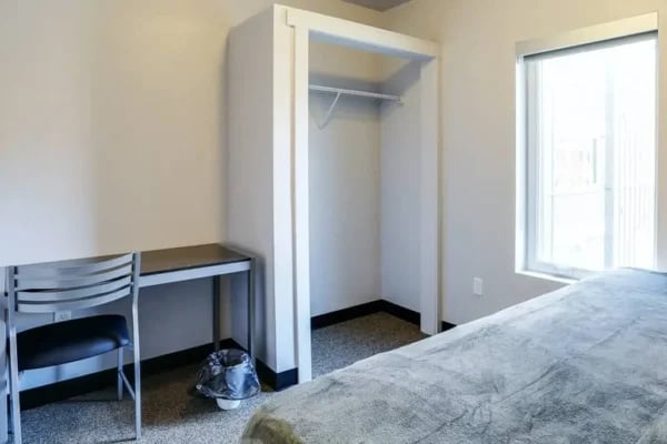 Desk chair empty closet bed window bedroom at The Factory Student Housing in Logan Student Accommodation