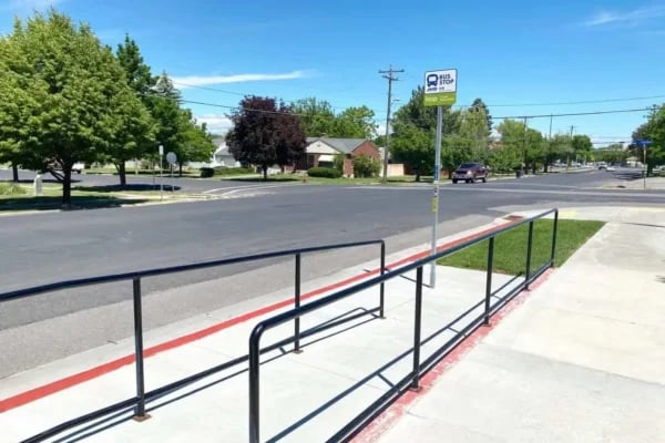 Bus stop with ramp and black rails exterior at The Factory Student Housing in Logan Student Accommodation