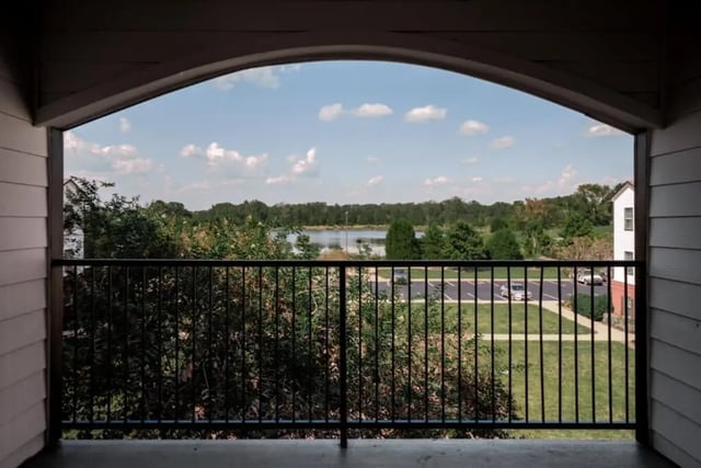 Balcony view of lake trees parking lot exterior at Lakeside Student Living in Starkville Student Accommodation