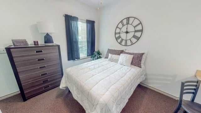 Chest bed clock window plant bedroom at Lakeside Student Living in Starkville Student Accommodation
