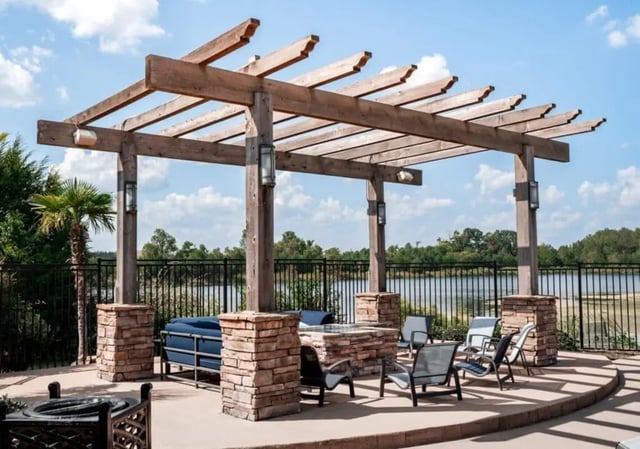 Wooden pergola with chairs and sofa outdoor living area at Lakeside Student Living in Starkville Student Accommodation