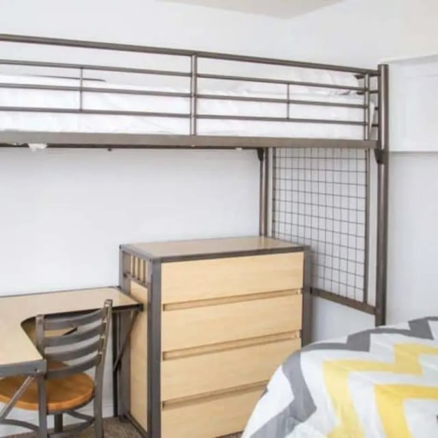 Loft bed desk dresser chair bedroom interior at The Pines in Rexburg Student Accommodation