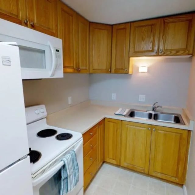 Kitchen with white oven double sink wooden cabinets kitchen at The Pines in Rexburg Student Accommodation