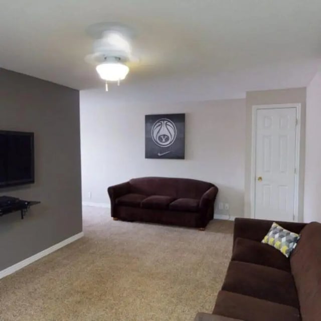 Two brown couches artwork and TV living room at The Pines in Rexburg Student Accommodation