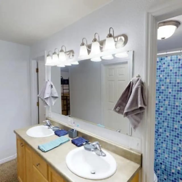 Double sinks vanity light towels shower curtain bathroom at The Pines in Rexburg Student Accommodation