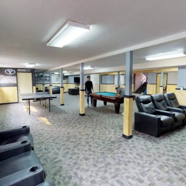 Ping pong table pool table lounge chairs living room at The Pines in Rexburg Student Accommodation
