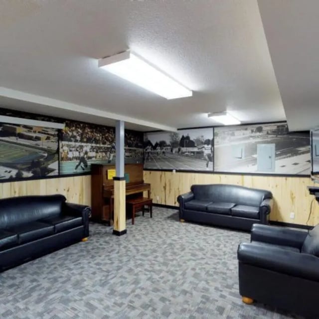 Sofas piano and murals lounge area at The Pines in Rexburg Student Accommodation