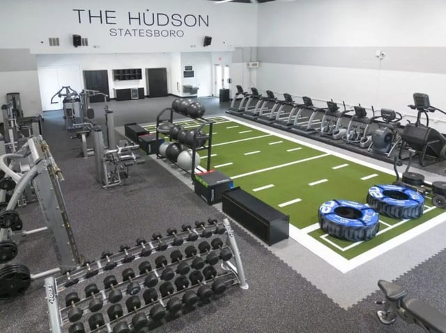 Dumbbells treadmills weights and artificial turf gymnasium at The Hudson in Albany Student Accommodation