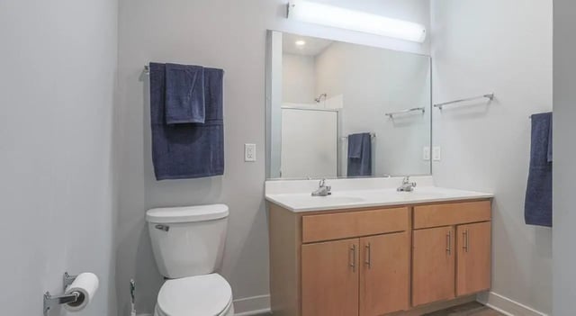 Toilet towels double vanity with mirror Bathroom at Lancaster Apartments in Champaign Student Accommodation