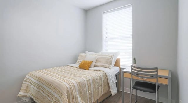 Bed with desk and chair bedroom at Lancaster Apartments in Champaign Student Accommodation