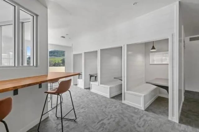 Study booths with white benches and wood table study area at Summit SLO in San Luis Obispo Student Accommodation