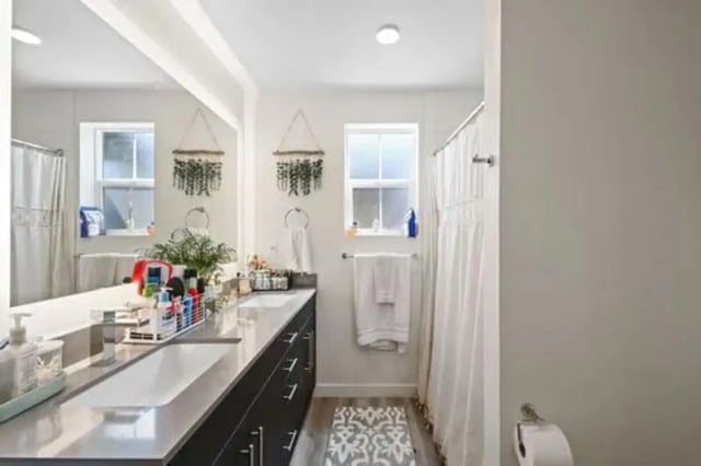 Sink counter toiletries and shower curtain bathroom at Summit SLO in San Luis Obispo Student Accommodation