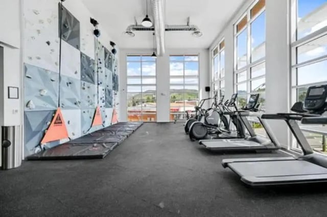 Climbing wall treadmills and ellipticals gym area at Summit SLO in San Luis Obispo Student Accommodation