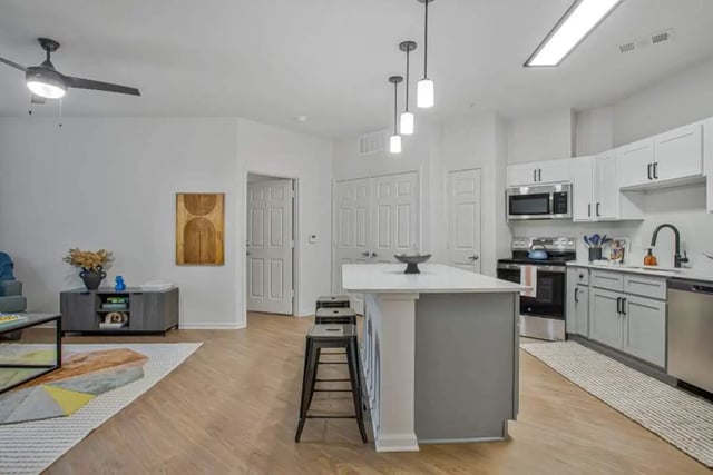Island stools kitchen counters cabinets and appliances kitchen at Mazza GrandMarc in College Park Student Accommodation