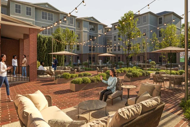 Courtyard seating lounge area with string lights exterior at Mazza GrandMarc in College Park Student Accommodation