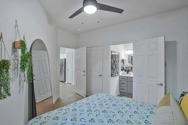 Bed with plants mirror and bathroom Bedroom at Mazza GrandMarc in College Park Student Accommodation