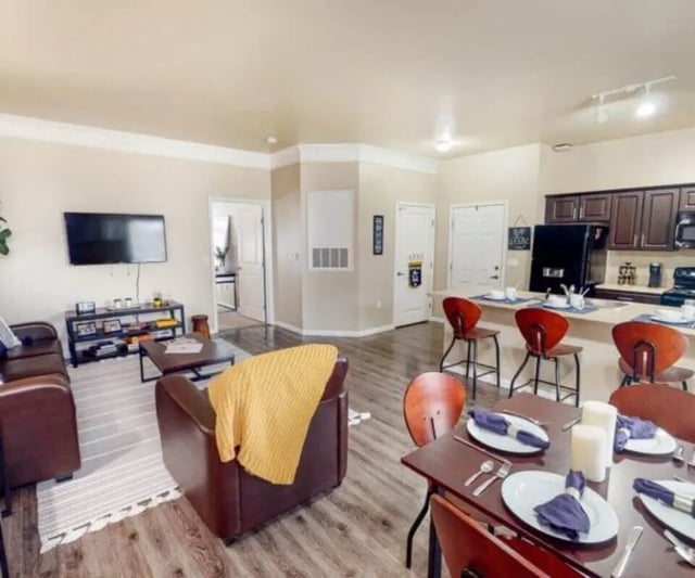 Sofa table television kitchen dining area living room at University Edge Apartments Bldg 1 in South Bend Student Accommodation