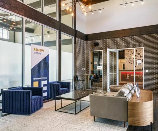 Modern lobby with sofas and coffee table lounge area at University Edge Apartments Bldg 1 in South Bend Student Accommodation