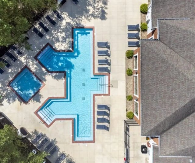 Pool with lounge chairs and adjacent building exterior at University Edge Apartments Bldg 1 in South Bend Student Accommodation