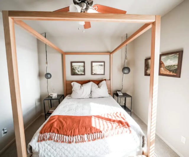 Four poster bed with orange throw artwork bedroom at The Hamptons Statesboro in Statesboro Student Accommodation