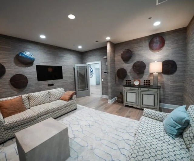 Two sofas wall decor TV and cabinet living room at The Hamptons Statesboro in Statesboro Student Accommodation