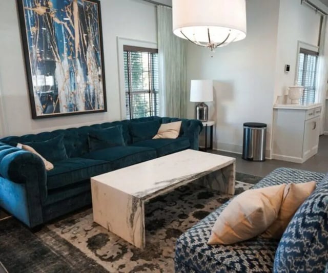 Dark teal sofa marble coffee table modern living room at The Hamptons Statesboro in Statesboro Student Accommodation