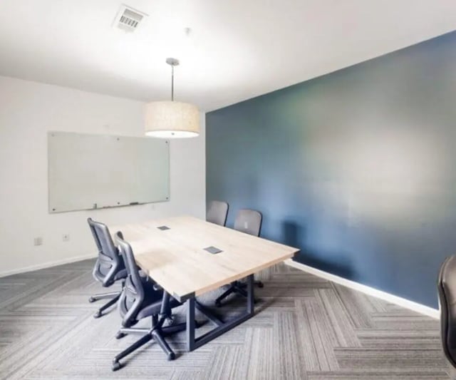 Table chairs whiteboard meeting room at The Hamptons Statesboro in Statesboro Student Accommodation