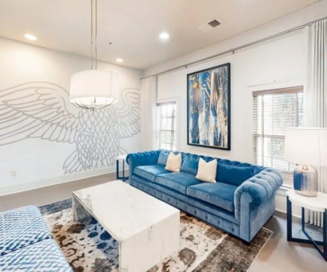 Blue tufted sofa marble coffee table living room at The Hamptons Statesboro in Statesboro Student Accommodation