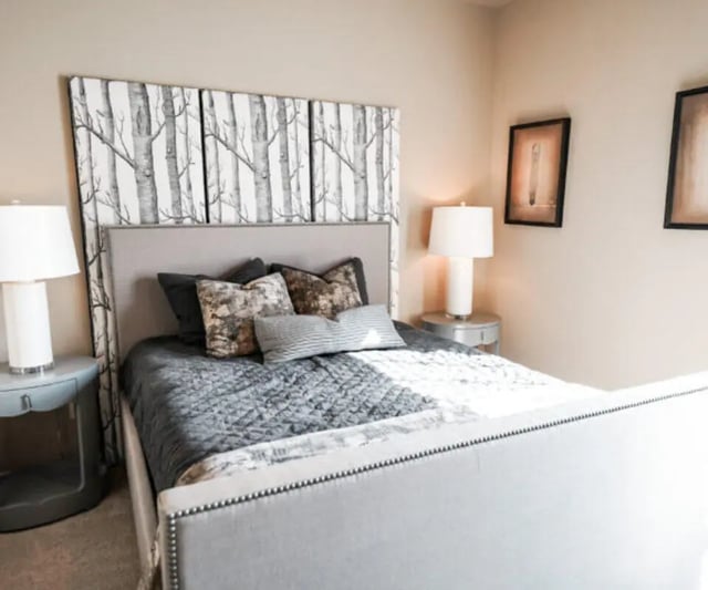 Bed with patterned headboard nightstands lamps bedroom at The Hamptons Statesboro in Statesboro Student Accommodation