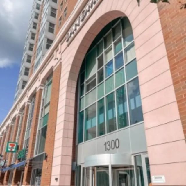 Building entrance with arched windows and revolving door exterior at Landmark Apartments in Ann Arbor Student Accommodation
