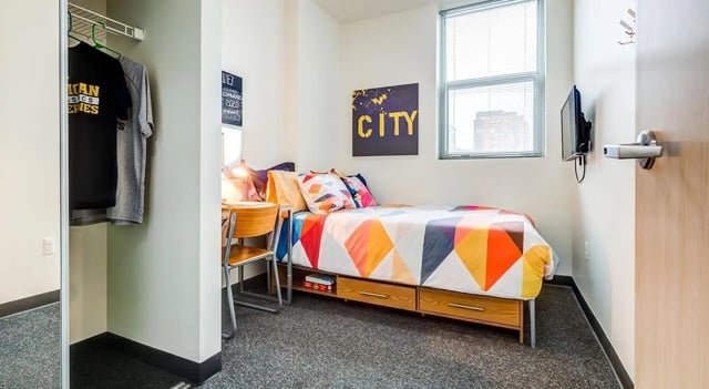 Bed desk and closet student accommodation bedroom at Landmark Apartments in Ann Arbor Student Accommodation