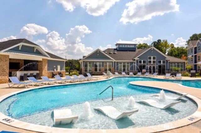 Luxury pool with lounge chairs and fountains exterior at Stadium View in Ames Student Accommodation