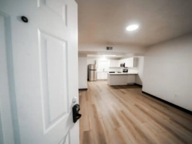Open door view of kitchen with stainless steel refrigerator kitchen area at Village on the Parkway in Orem Student Accommodation