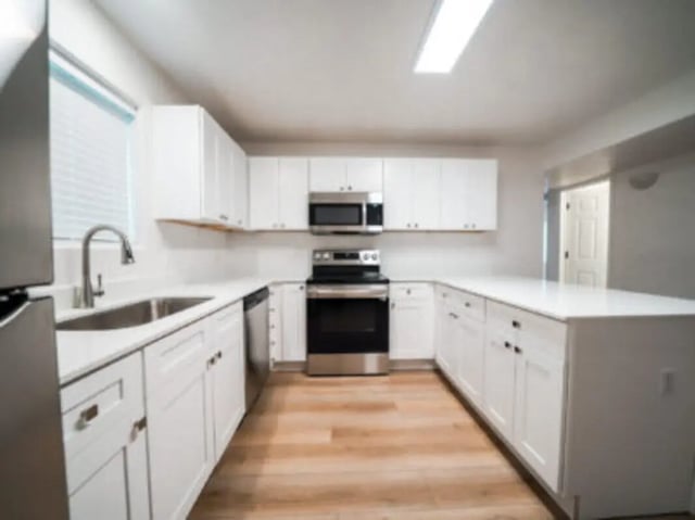 White cabinets sink stove refrigerator and island Kitchen at Village on the Parkway in Orem Student Accommodation