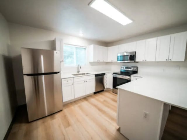 Stainless steel fridge white cabinets sink stove microwave kitchen at Village on the Parkway in Orem Student Accommodation