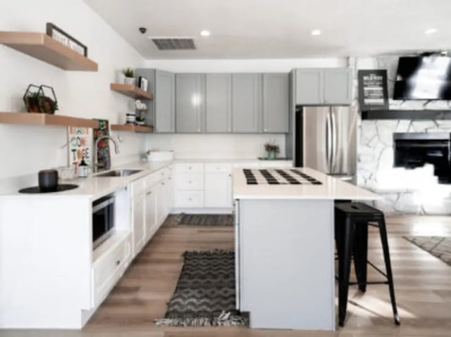 Kitchen with island microwave and fireplace kitchen at Village on the Parkway in Orem Student Accommodation
