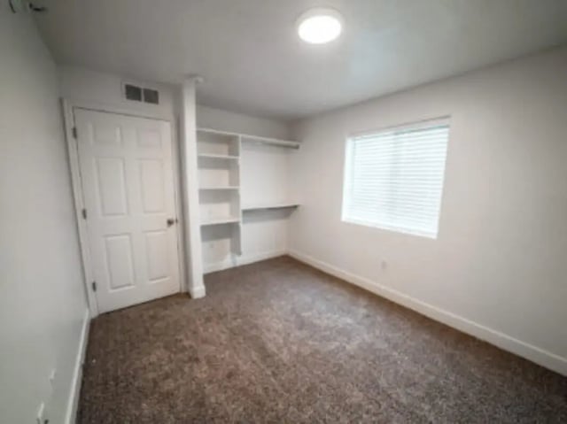 Door window shelves and carpeted room bedroom at Village on the Parkway in Orem Student Accommodation