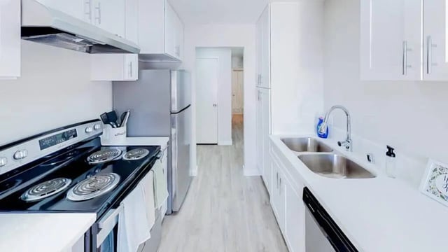 Modern white kitchen with stainless steel appliances kitchen at Wildcat Crossing in Chico Student Accommodation