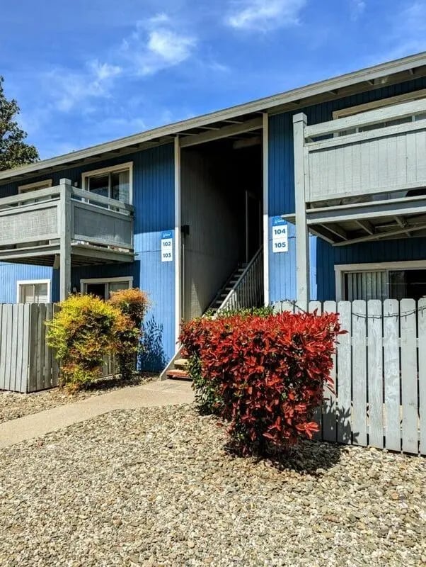 Blue building with balconies stairs and greenery exterior at Wildcat Crossing in Chico Student Accommodation