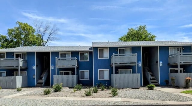 Blue apartment building with stairs and balconies exterior at Wildcat Crossing in Chico Student Accommodation
